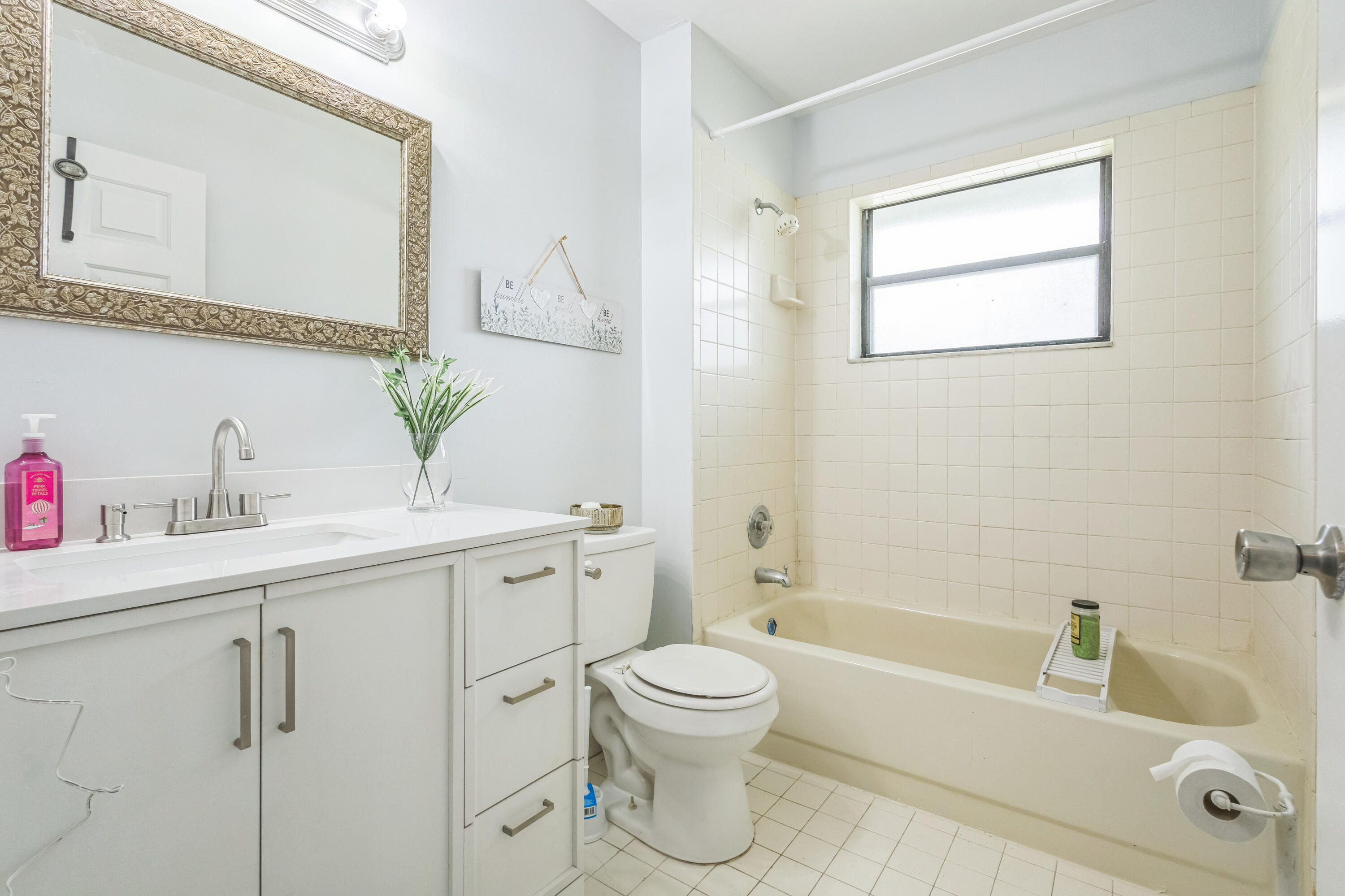 6537 Southeast Federal Highway, Unit 202 Stuart, FL 34997 - Photo 7 of 14 a bathroom with a sink a toilet and shower