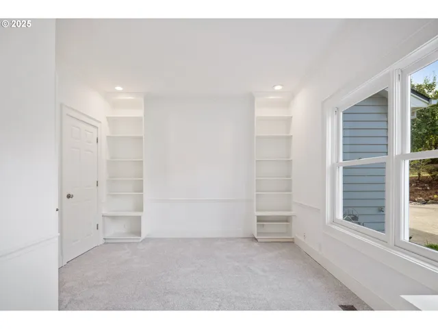 a view of an empty room with a window