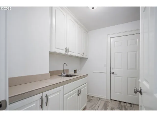 a kitchen with a sink and cabinets