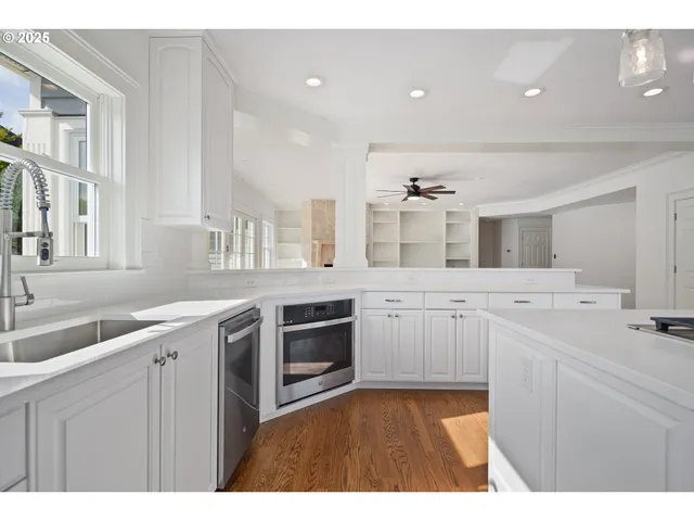 a kitchen with a sink stove and cabinets