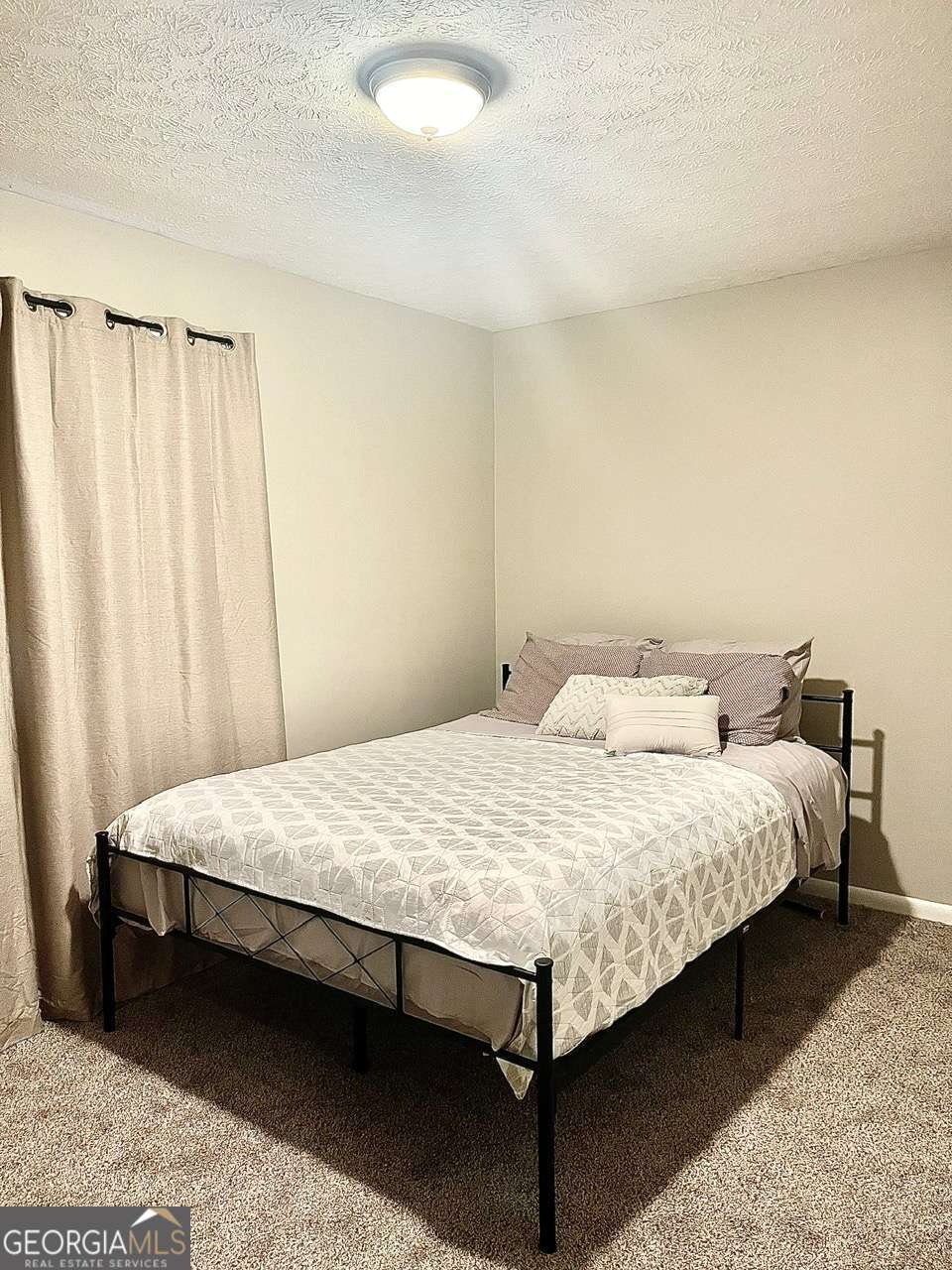 3608 Radcliffe Boulevard Decatur, GA 30034 - Photo 12 of 19 a bedroom with a bed table and curtain