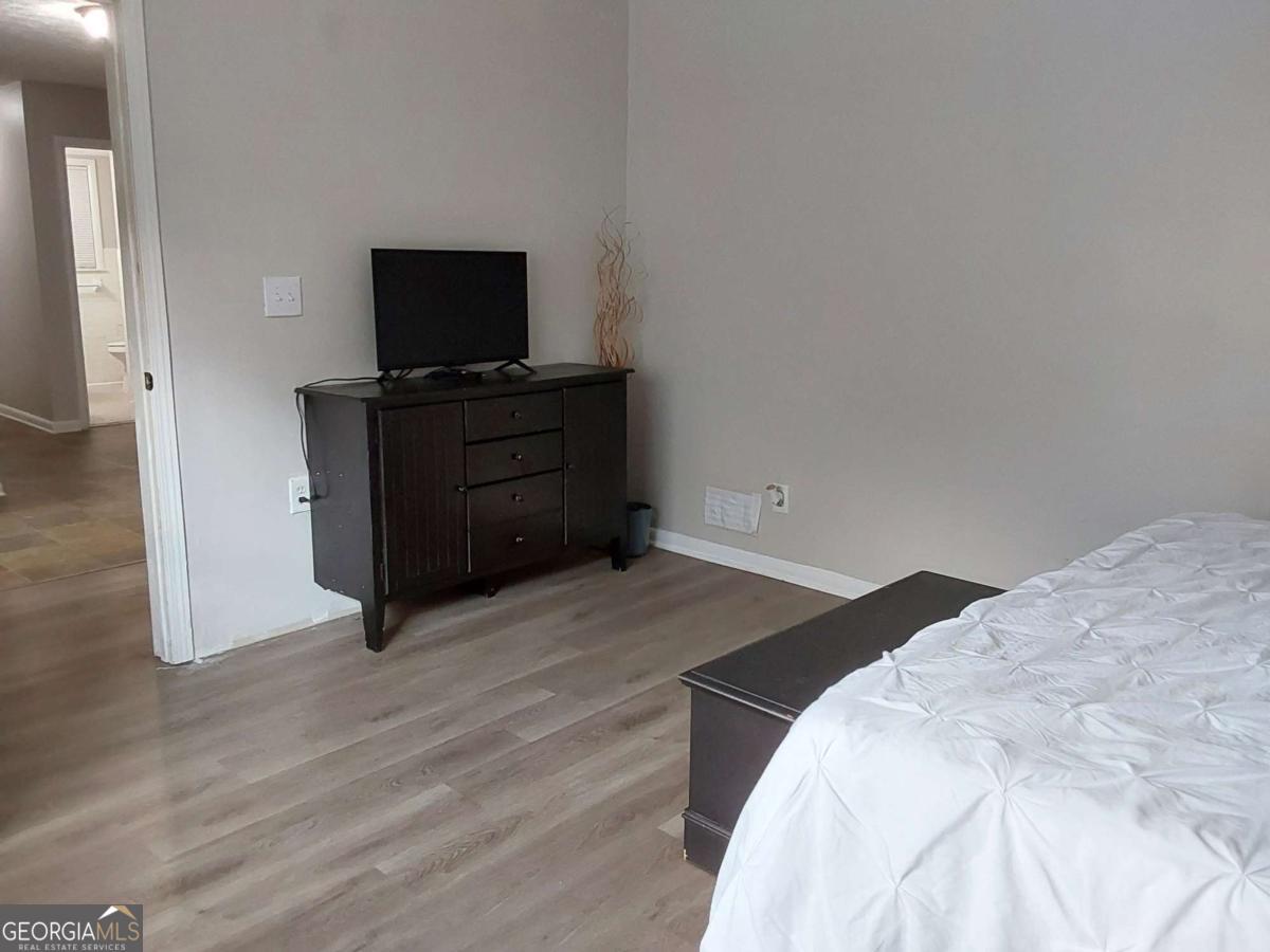 3608 Radcliffe Boulevard Decatur, GA 30034 - Photo 13 of 19 a bedroom with a bed and flat screen tv