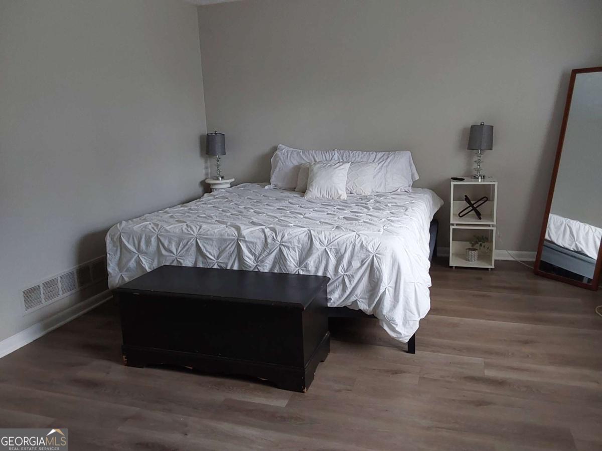 3608 Radcliffe Boulevard Decatur, GA 30034 - Photo 15 of 19 a bed sitting in a bedroom next to a tv