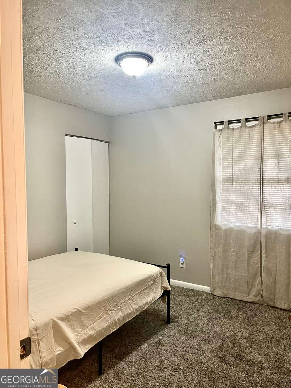 3608 Radcliffe Boulevard Decatur, GA 30034 - Photo 18 of 19 a bedroom with a bed and a window