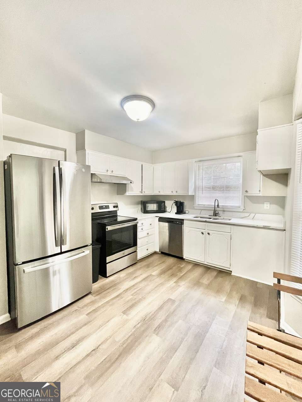 3608 Radcliffe Boulevard Decatur, GA 30034 - Photo 7 of 19 a large kitchen with white cabinets and stainless steel appliances
