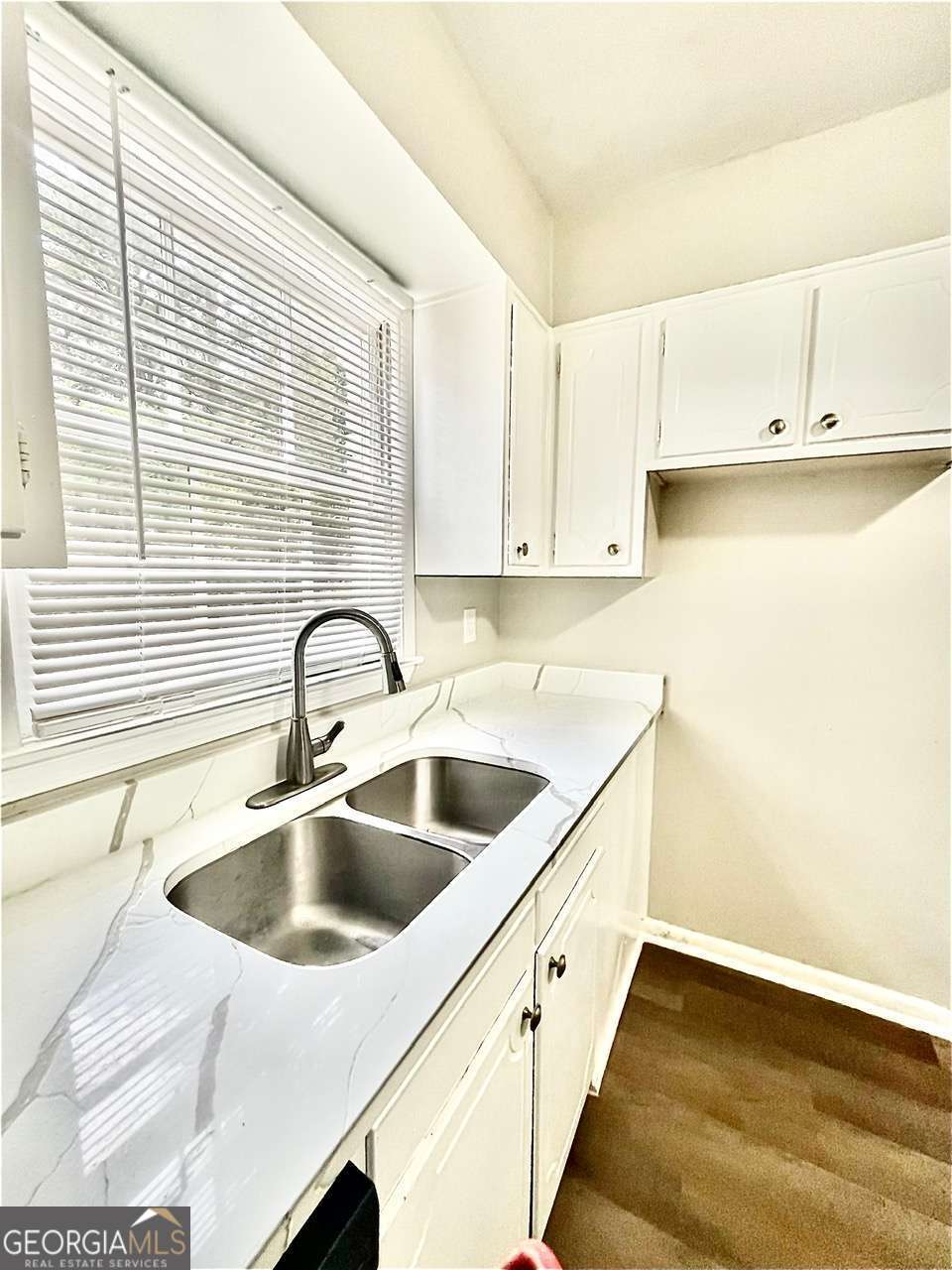 3608 Radcliffe Boulevard Decatur, GA 30034 - Photo 8 of 19 a kitchen with white cabinets a sink and a window
