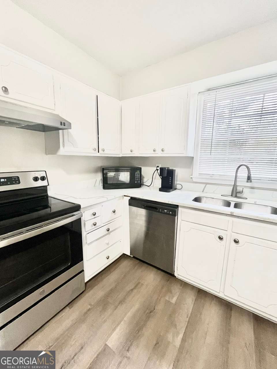3608 Radcliffe Boulevard Decatur, GA 30034 - Photo 9 of 19 a kitchen with white cabinets stainless steel appliances and sink
