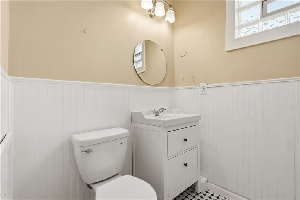 218 39th Street Pittsburgh, PA 15201 - Photo 14 of 24 a bathroom with a toilet sink vanity and mirror