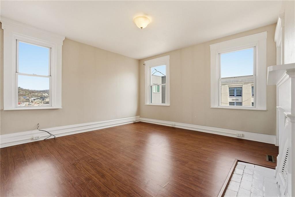 218 39th Street Pittsburgh, PA 15201 - Photo 18 of 24 a view of an empty room with wooden floor and a window