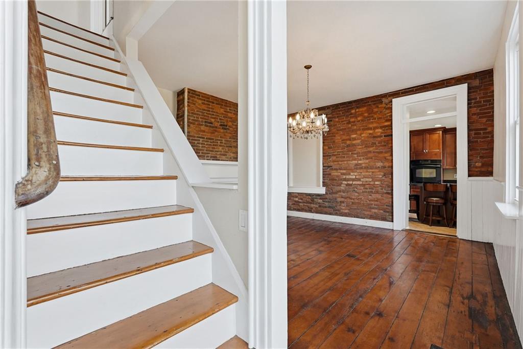 218 39th Street Pittsburgh, PA 15201 - Photo 4 of 24 a view of a hallway with wooden floor and staircase