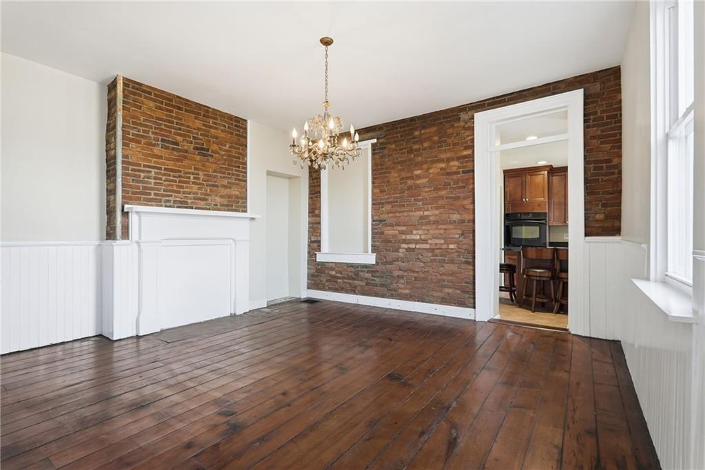 218 39th Street Pittsburgh, PA 15201 - Photo 5 of 24 a view of an empty room with wooden floor and a window