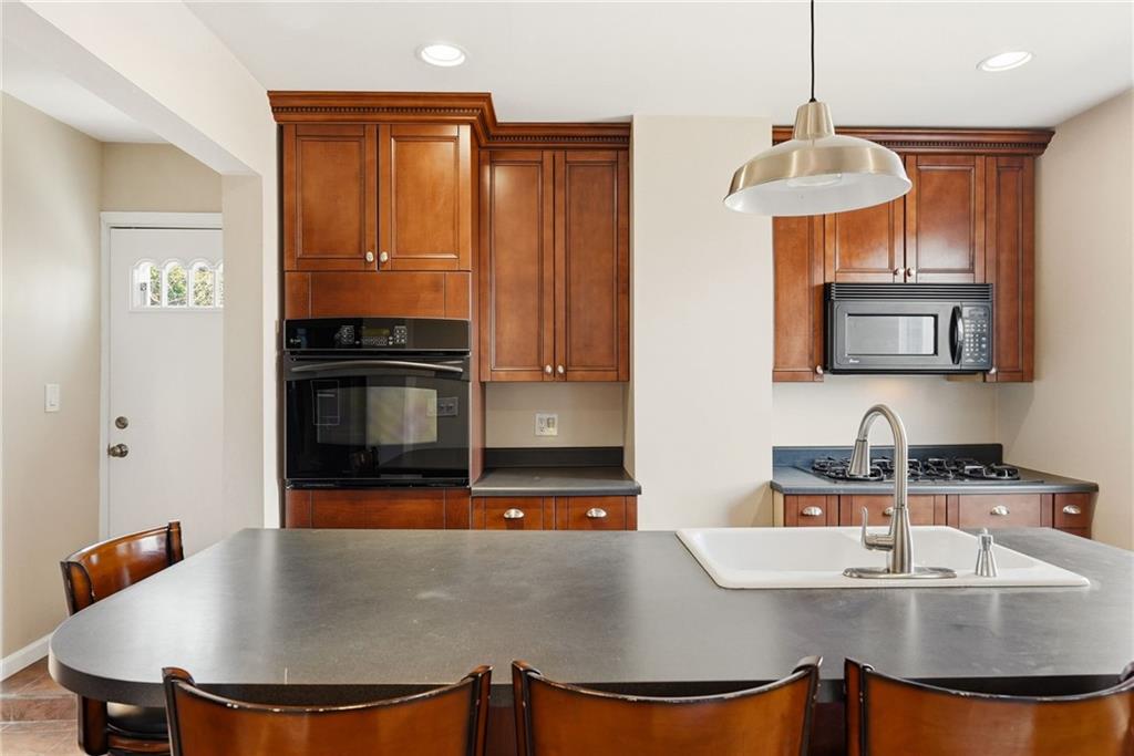 218 39th Street Pittsburgh, PA 15201 - Photo 9 of 24 a kitchen with stainless steel appliances granite countertop a sink a stove and a refrigerator