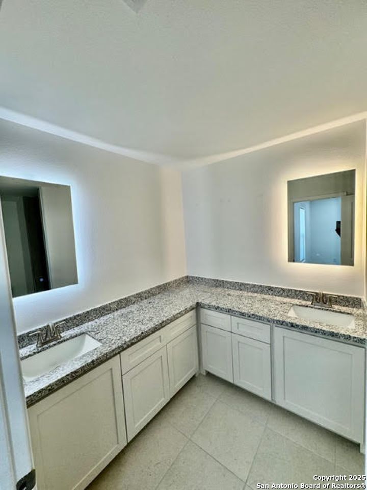 4031 Colibri Drive Laredo, TX 78046 - Photo 12 of 23 a spacious bathroom with a granite countertop sink and a mirror