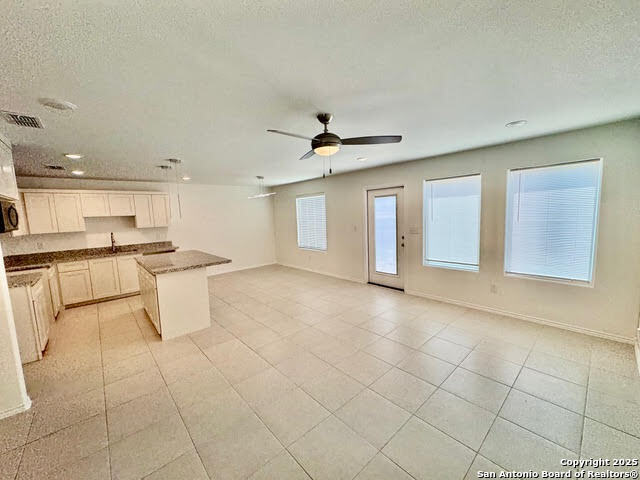 4031 Colibri Drive Laredo, TX 78046 - Photo 4 of 23 a view of an empty room with kitchen view and a window