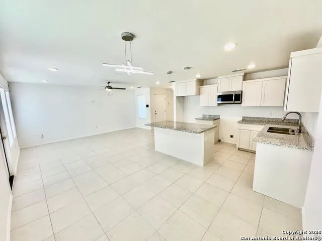 a kitchen with stainless steel appliances a stove a sink and a refrigerator