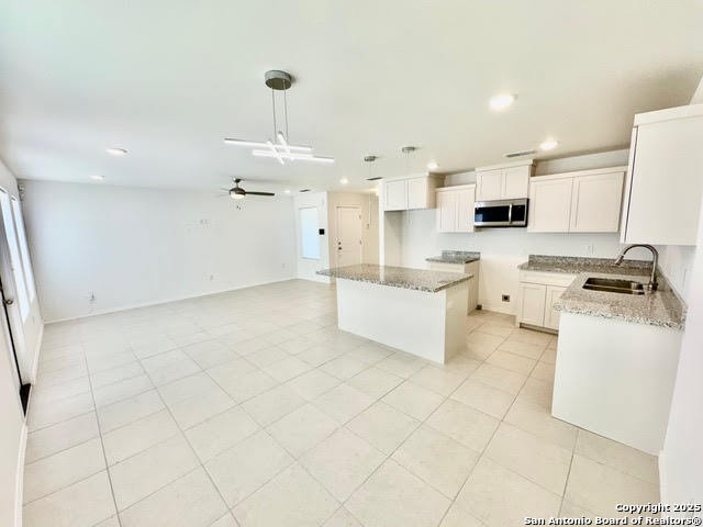 4031 Colibri Drive Laredo, TX 78046 - Photo 6 of 23 a kitchen with stainless steel appliances a stove a sink and a refrigerator