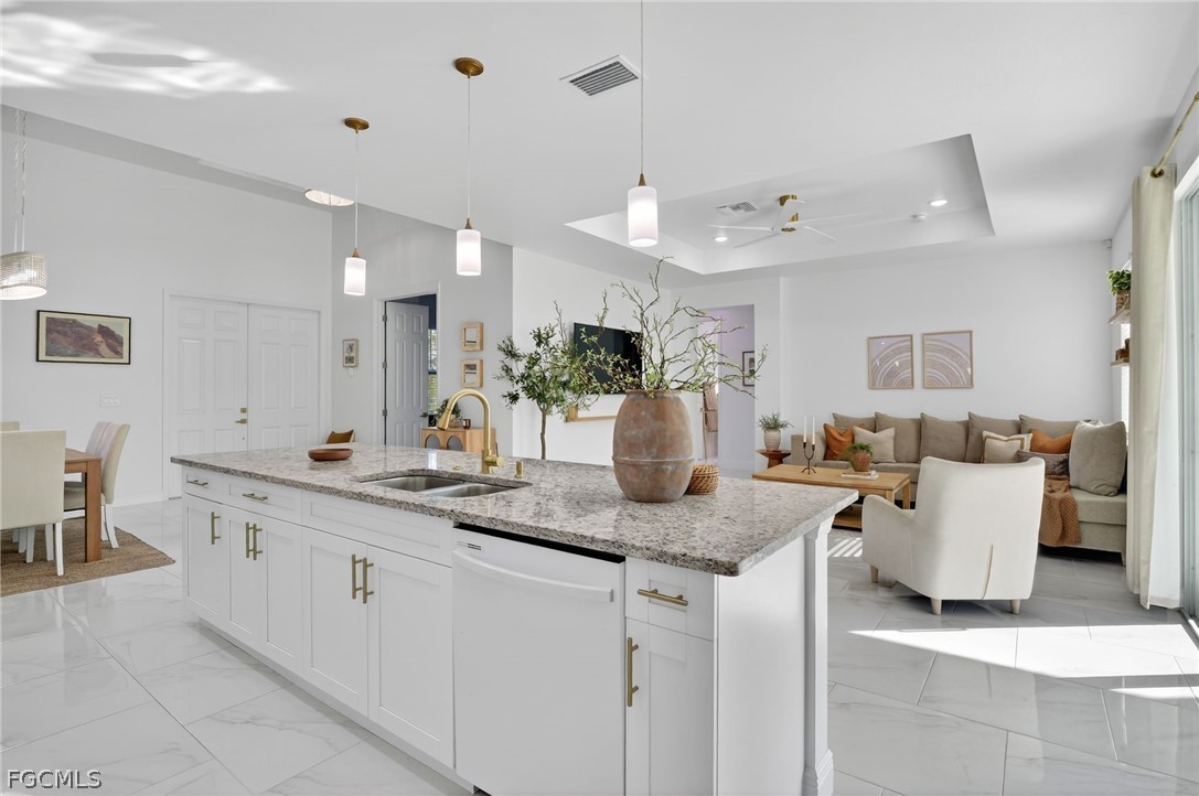 1207 Sheldon Avenue Lehigh Acres, FL 33972 - Photo 12 of 48 a large white kitchen with a lot of white cabinets and couches