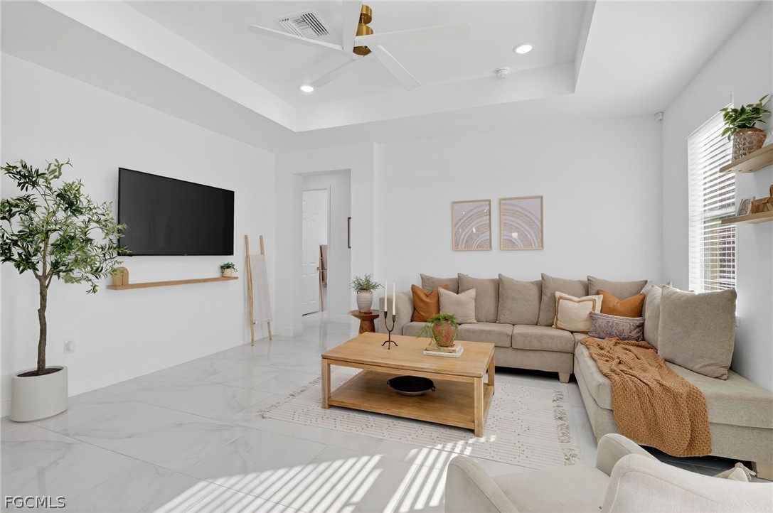 1207 Sheldon Avenue Lehigh Acres, FL 33972 - Photo 13 of 48 a living room with furniture and a flat screen tv
