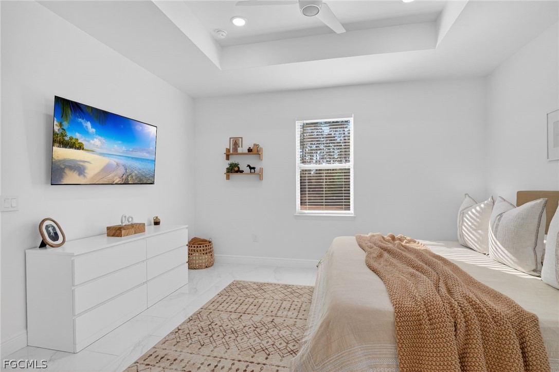 1207 Sheldon Avenue Lehigh Acres, FL 33972 - Photo 17 of 48 a bedroom with a bed and a lamp on dresser