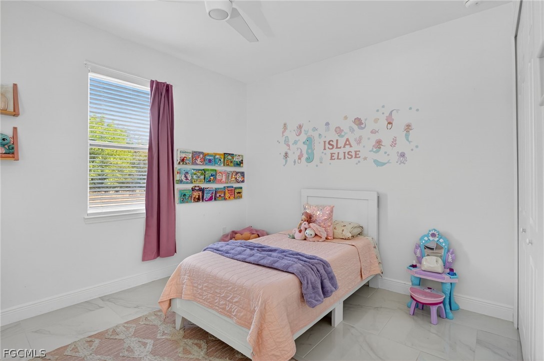 1207 Sheldon Avenue Lehigh Acres, FL 33972 - Photo 23 of 48 a bedroom with a bed and a window