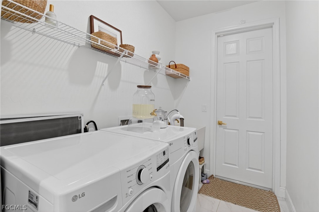 1207 Sheldon Avenue Lehigh Acres, FL 33972 - Photo 25 of 48 a utility room with dryer and washer