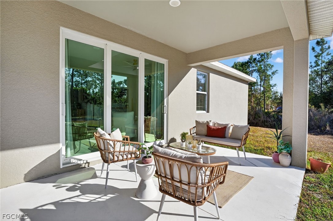 1207 Sheldon Avenue Lehigh Acres, FL 33972 - Photo 32 of 48 a outdoor living space with furniture and garden view