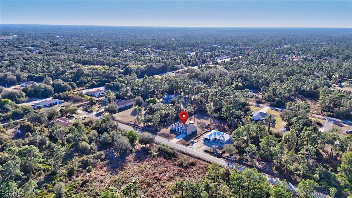 1207 Sheldon Avenue Lehigh Acres, FL 33972 - Photo 42 of 48 an aerial view of a house with a yard and lake view in back