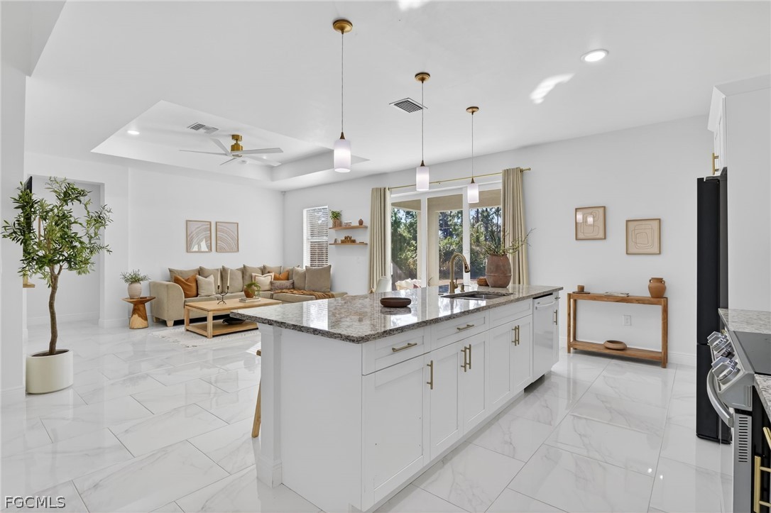 1207 Sheldon Avenue Lehigh Acres, FL 33972 - Photo 6 of 48 a large white kitchen with a large window