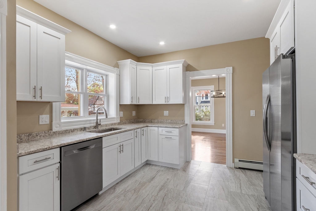 73 Cherry Street Gardner, MA 01440 - Photo 12 of 41 a kitchen with a sink cabinets stainless steel appliances and a window