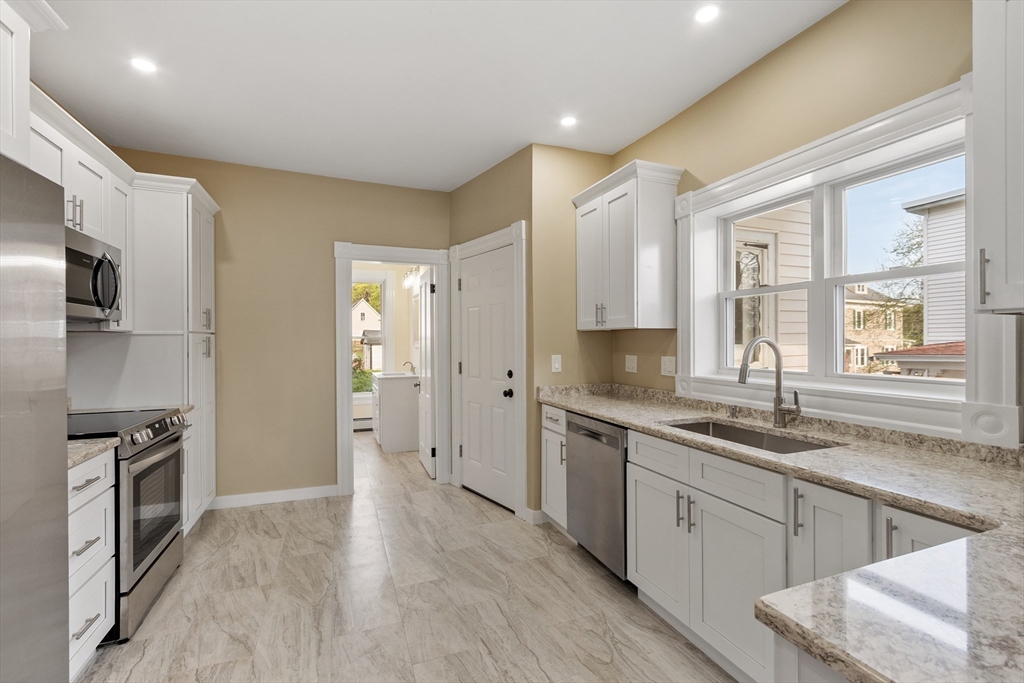 73 Cherry Street Gardner, MA 01440 - Photo 13 of 41 a kitchen with a sink stove and refrigerator