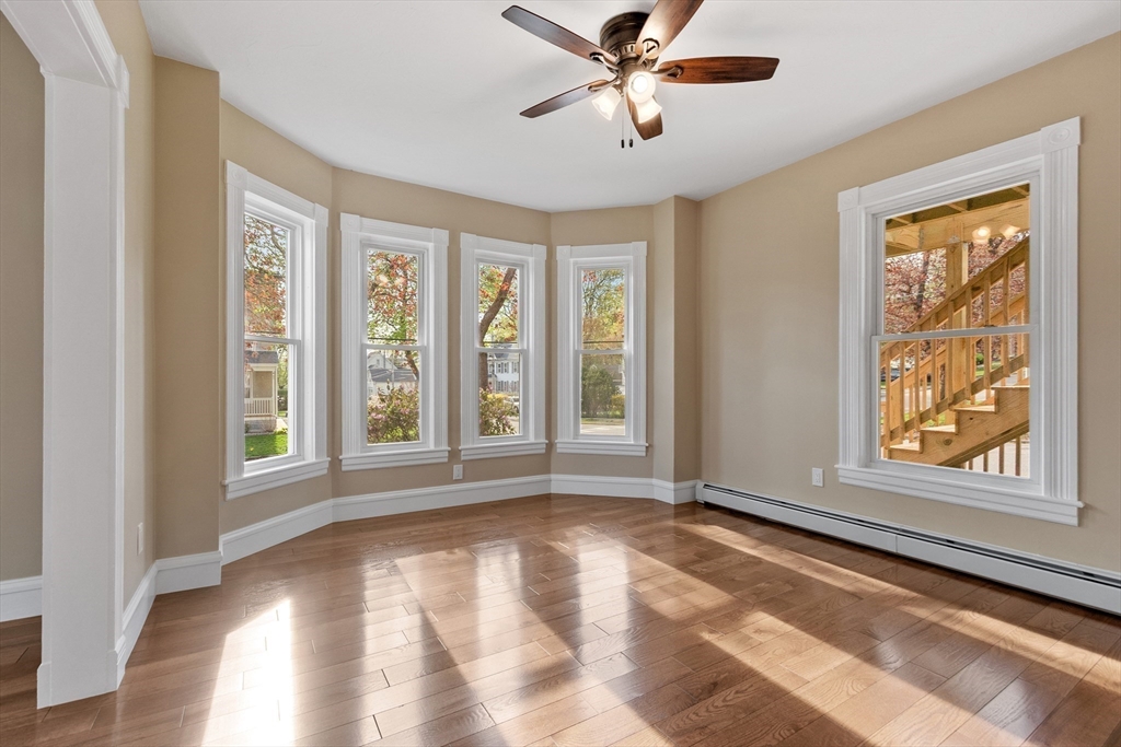 73 Cherry Street Gardner, MA 01440 - Photo 18 of 41 a view of an empty room with a window and wooden floor