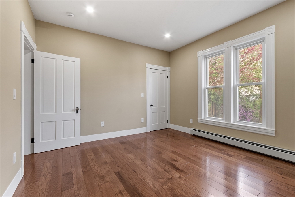 73 Cherry Street Gardner, MA 01440 - Photo 24 of 41 a view of an empty room with wooden floor and a window