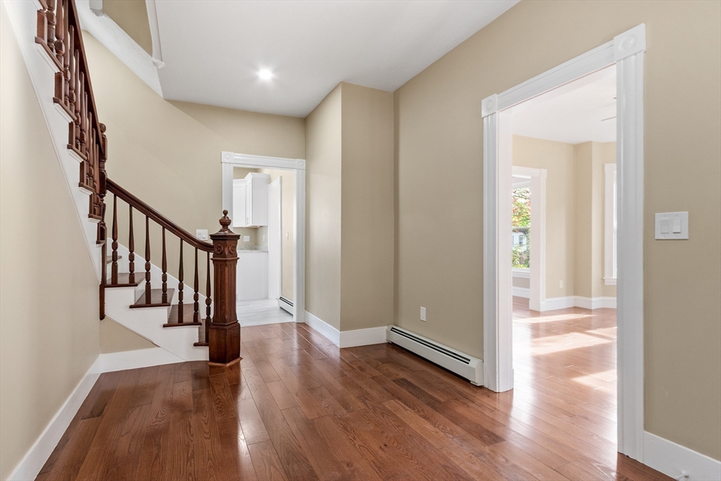 73 Cherry Street Gardner, MA 01440 - Photo 27 of 41 a view of a hallway with wooden floor and staircase