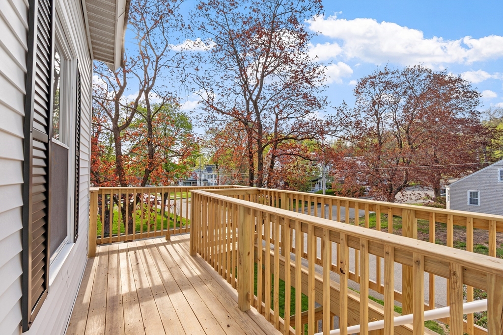 73 Cherry Street Gardner, MA 01440 - Photo 35 of 41 a view of a balcony with wooden floor and fence
