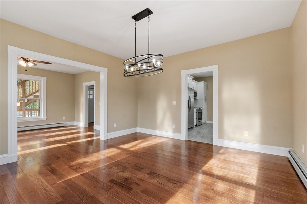73 Cherry Street Gardner, MA 01440 - Photo 10 of 41 a view of a hallway with wooden floor and a chandelier