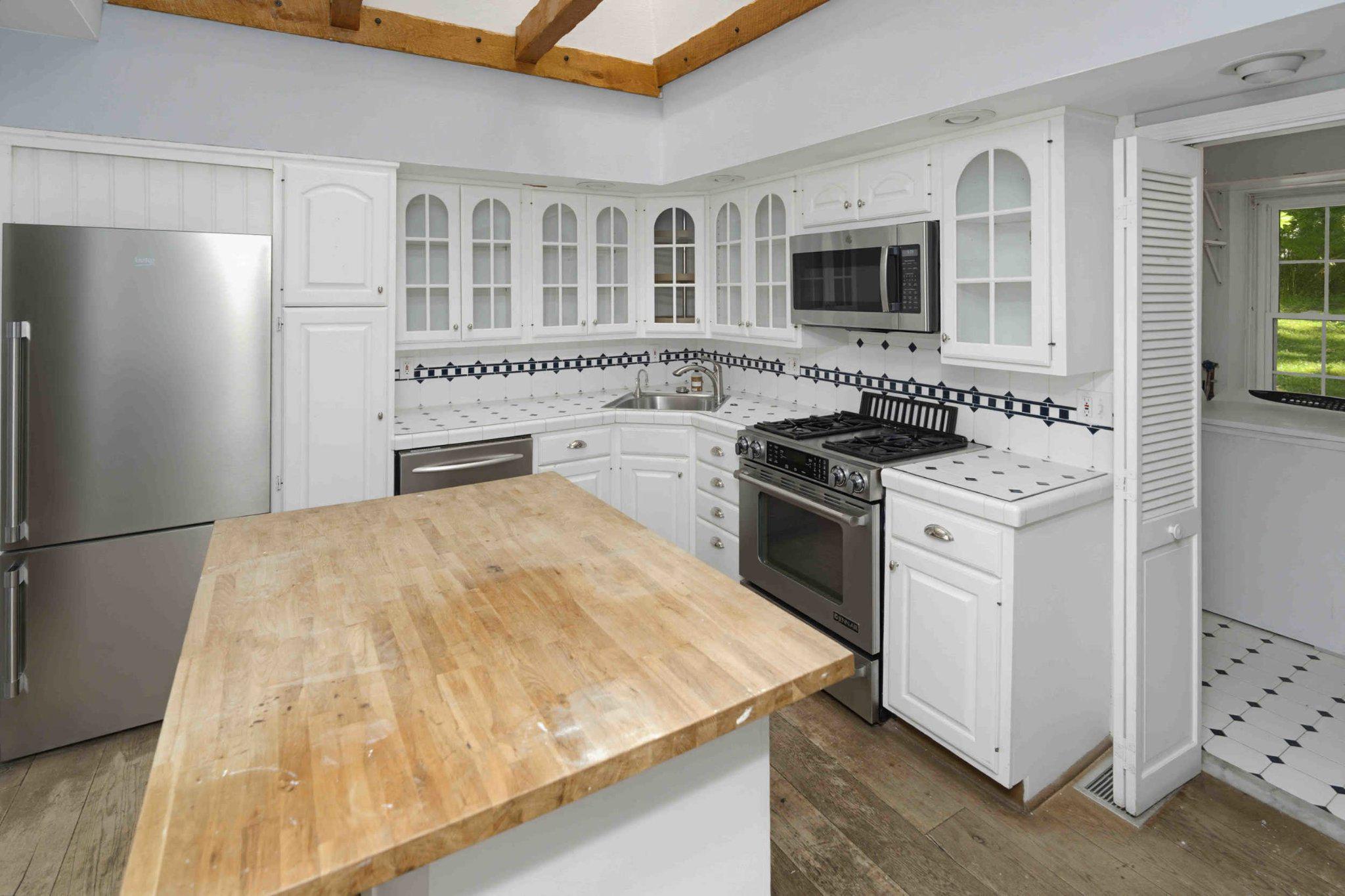 1268 Rydal Road Jenkintown, PA 19046 - Photo 11 of 31 a kitchen with a stove top oven a sink and a refrigerator