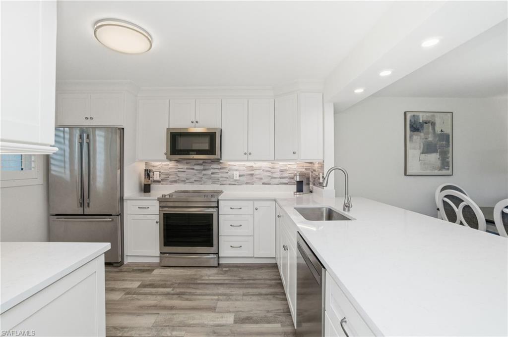 305 Goodlette-Frank Road, Unit C205 Naples, FL 34102 - Photo 7 of 26 Fresh and clean new kitchen with plenty of storage and prep space
