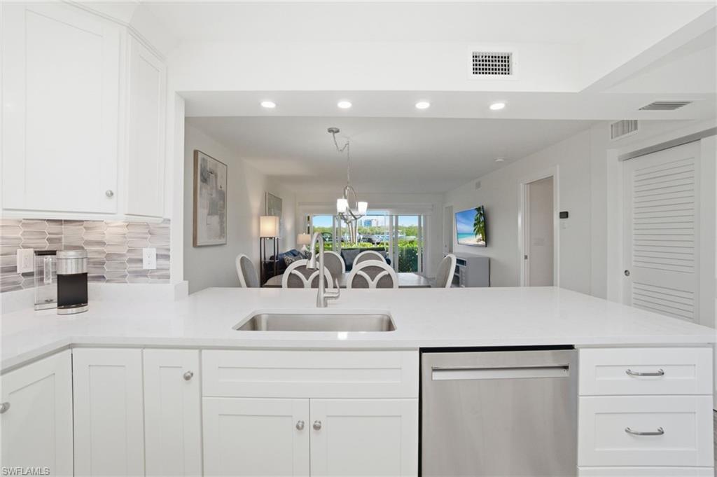 305 Goodlette-Frank Road, Unit C205 Naples, FL 34102 - Photo 8 of 26 Kitchen flows into the open concept dining and living area