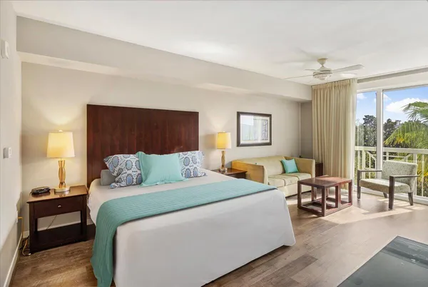 a bedroom with a large bed and a window