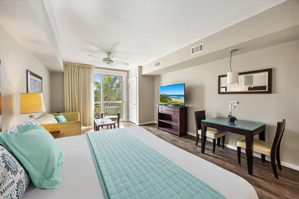 a kitchen with stainless steel appliances granite countertop white cabinets a refrigerator and a sink