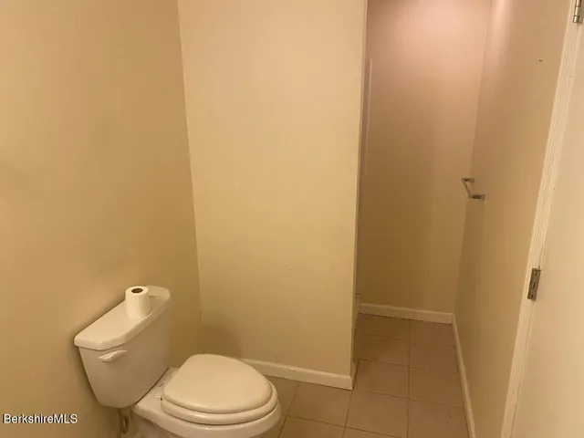 a white toilet sitting next to a shower