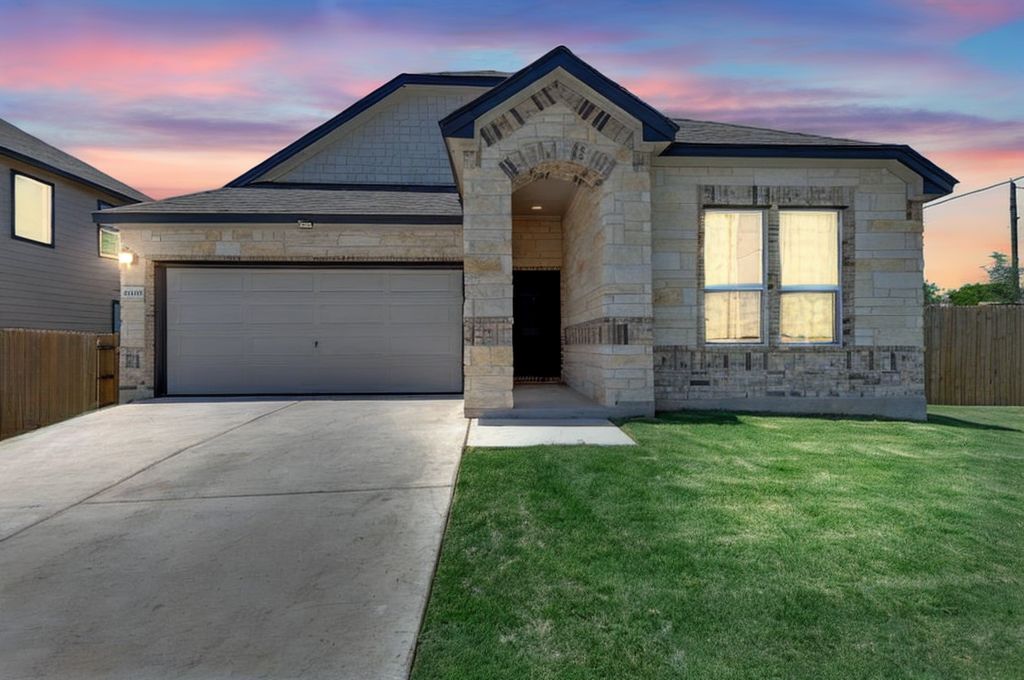 a view of a house with a yard and garage