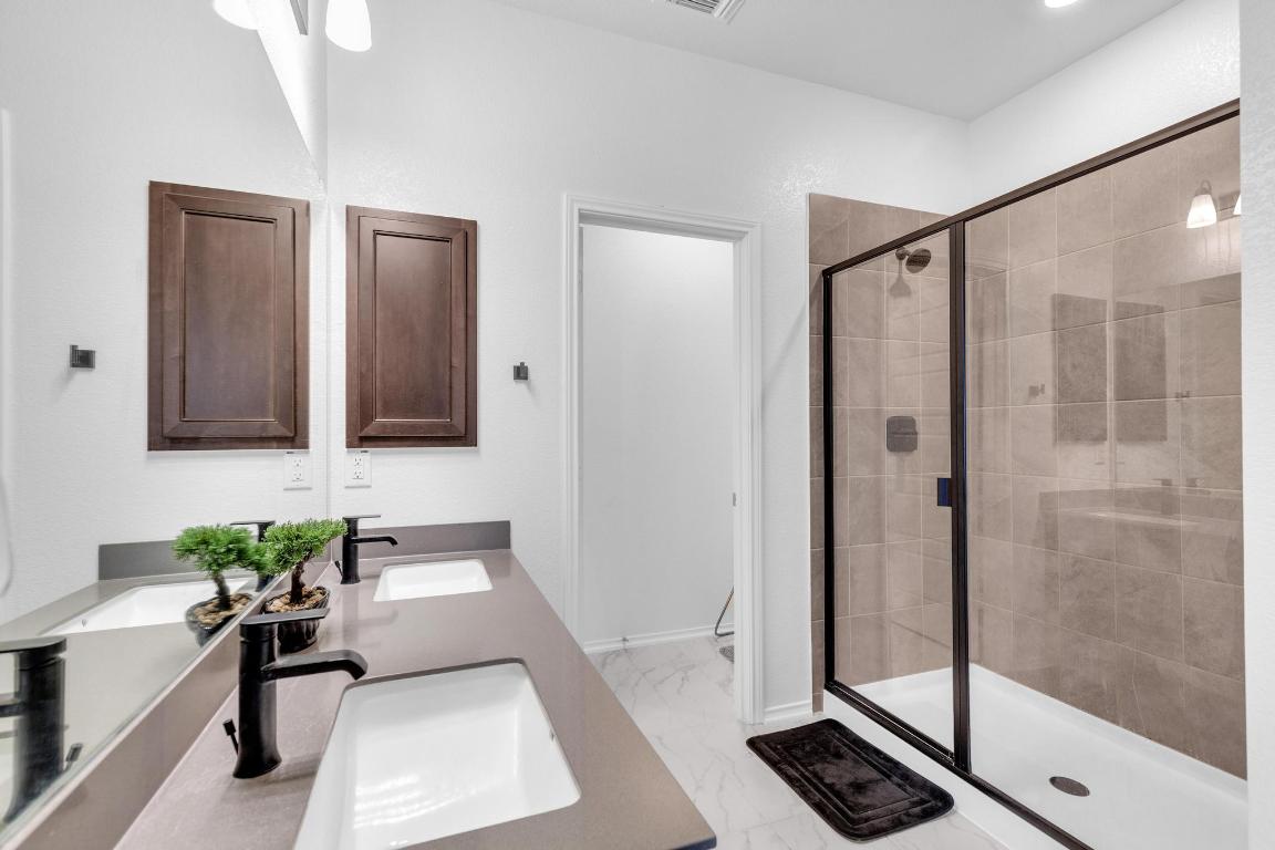 14516 Isidors Eagle Way Elgin, TX 78621 - Photo 11 of 21 a bathroom with a shower and a mirror
