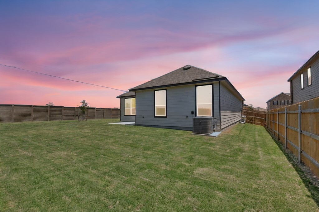 14516 Isidors Eagle Way Elgin, TX 78621 - Photo 16 of 21 a backyard of a house with lots of green space and mountain view