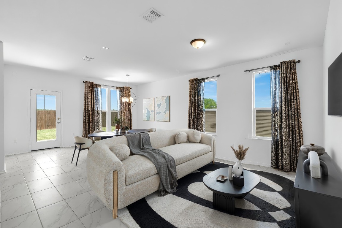 14516 Isidors Eagle Way Elgin, TX 78621 - Photo 2 of 21 a living room with furniture and wooden floor