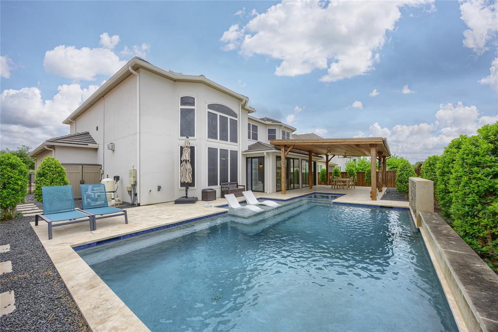 918 Sydney Lane Allen, TX 75013 - Photo 33 of 40 The property features a private swimming pool with integrated lounge seating and a surrounding paved patio