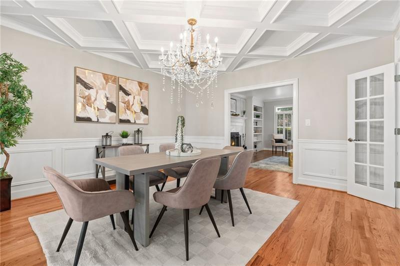 6030 Chimney Springs Road Buford, GA 30518 - Photo 18 of 110 a view of a dining room with furniture a chandelier and wooden floor