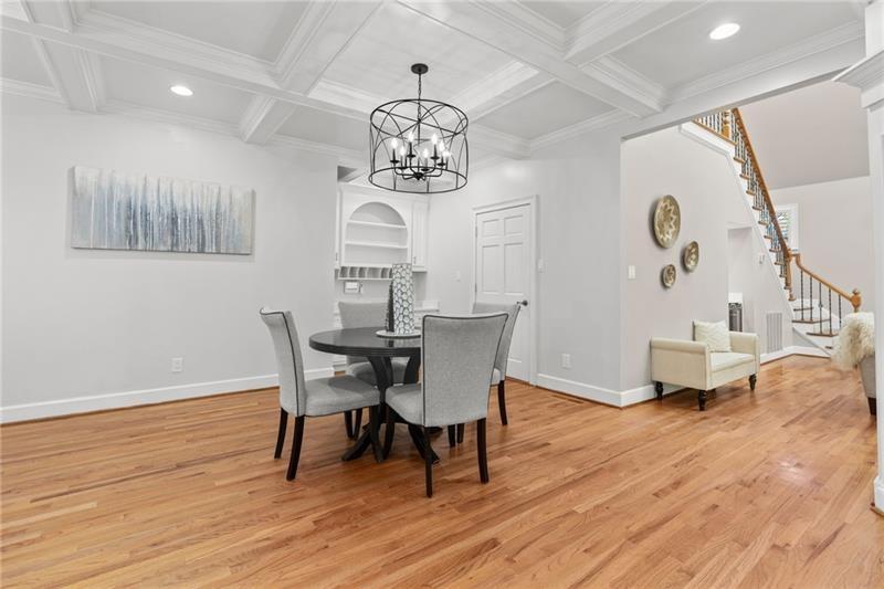 6030 Chimney Springs Road Buford, GA 30518 - Photo 27 of 110 a view of a dining room with furniture wooden floor and chandelier