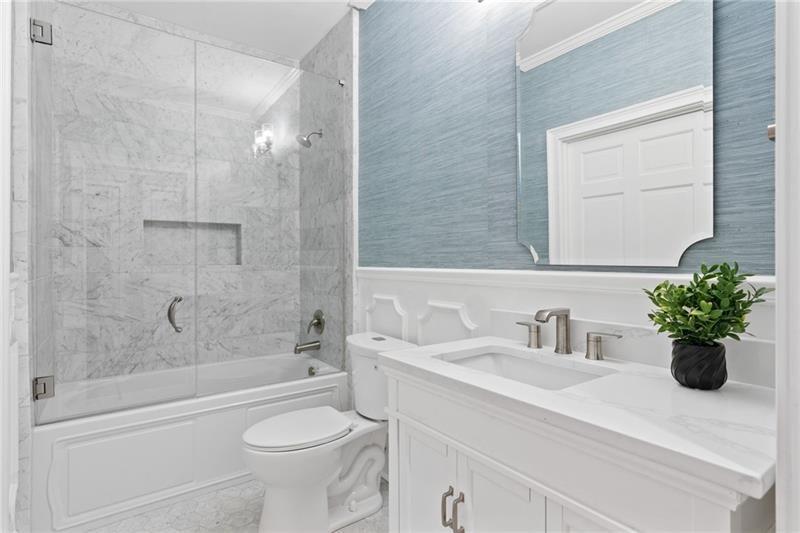 6030 Chimney Springs Road Buford, GA 30518 - Photo 41 of 110 a bathroom with a sink a toilet and shower