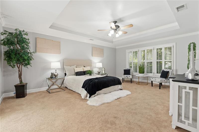 6030 Chimney Springs Road Buford, GA 30518 - Photo 44 of 110 a bedroom with a large bed and a potted plant